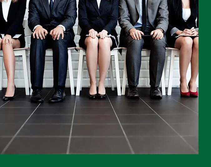 A group of people sitting in chairs on top of the floor.